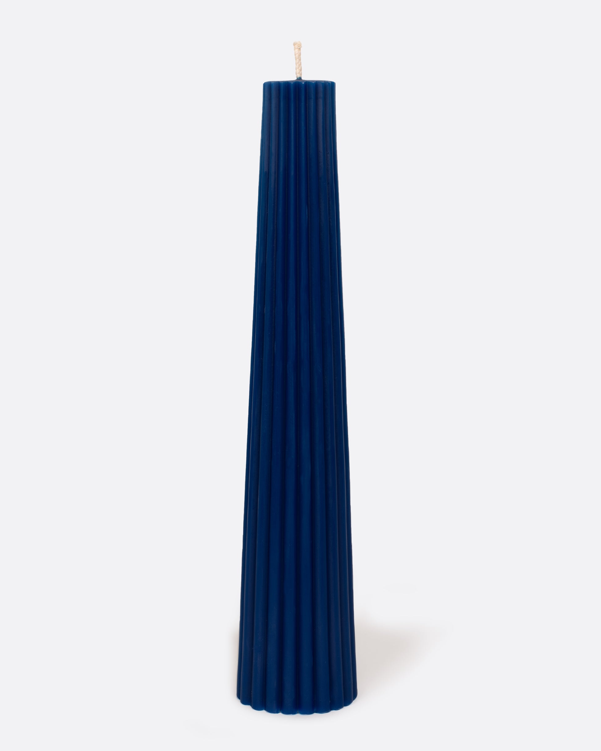Cobalt blue fluted pillar candle, shown standing.