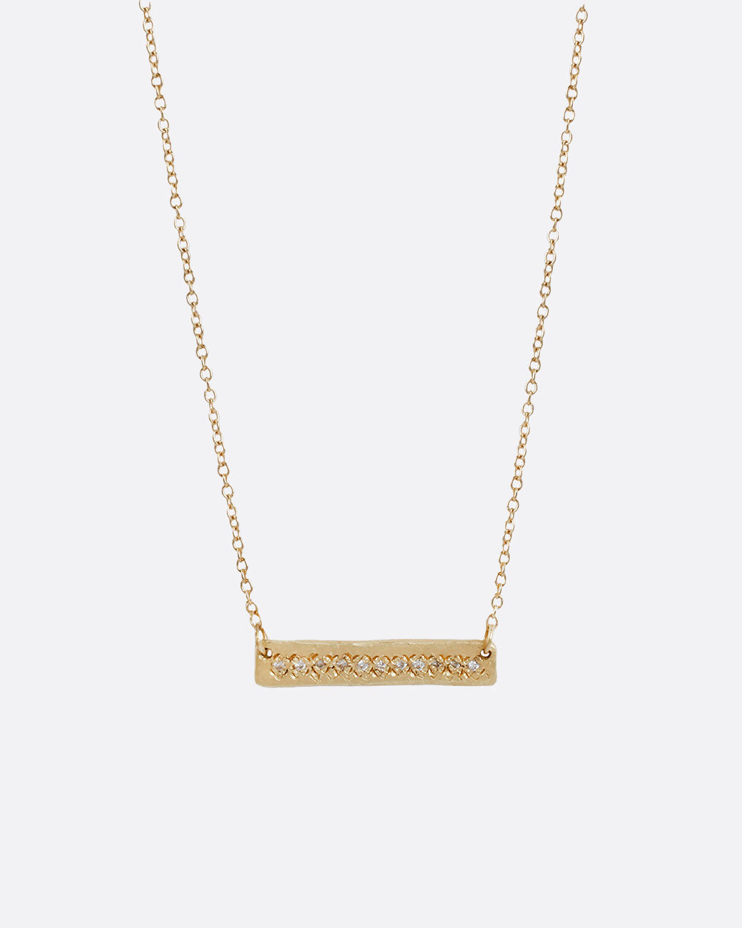 A yellow gold bar necklace with a single row of white diamonds.