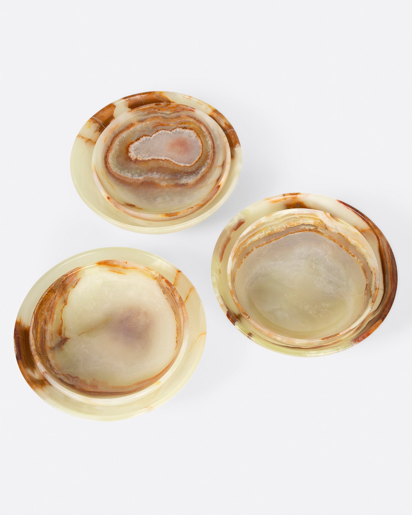 Three pairs of small and medium polished green onyx bowls, shown from above.