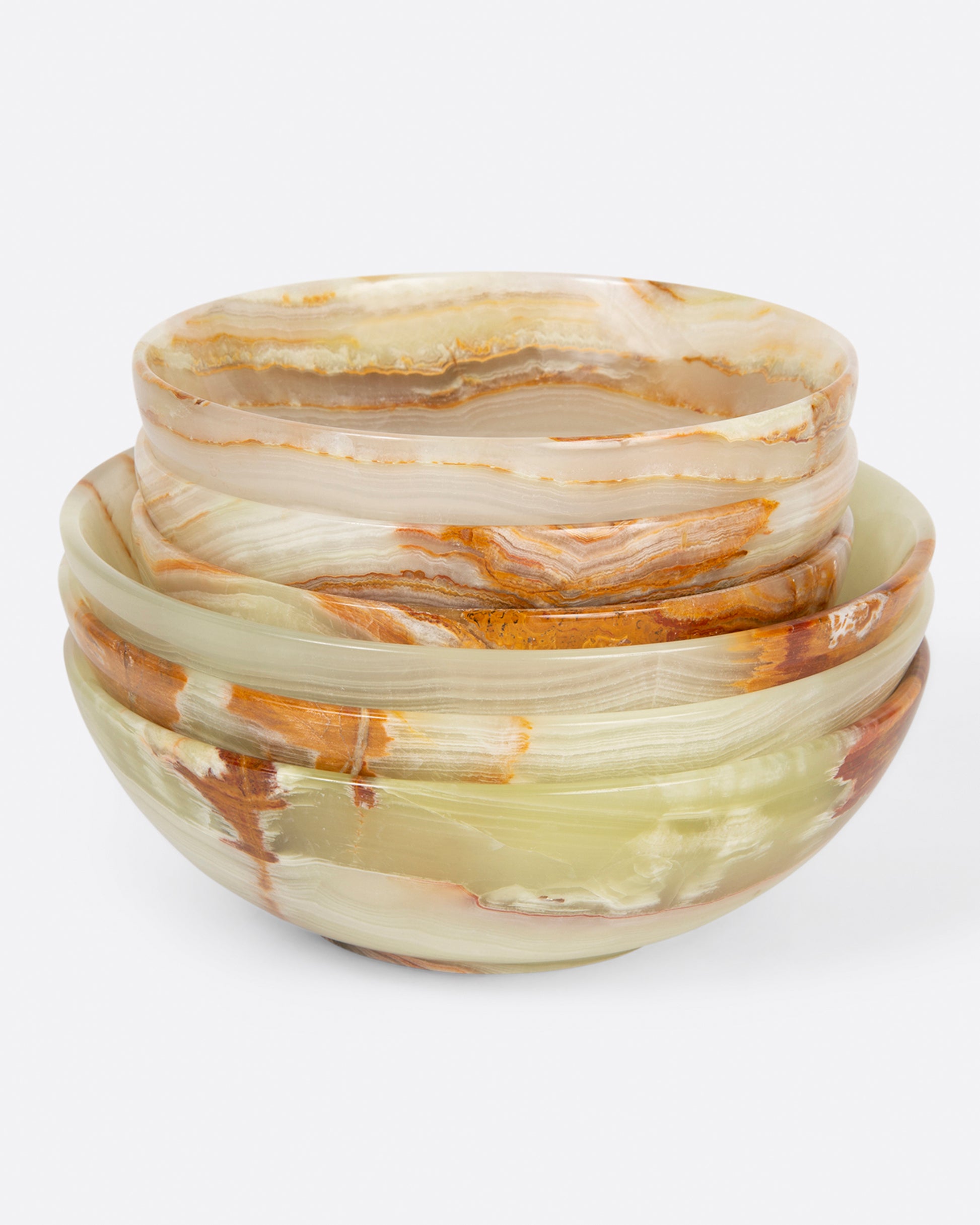 A stack of small and medium polished green onyx bowls shown from the front