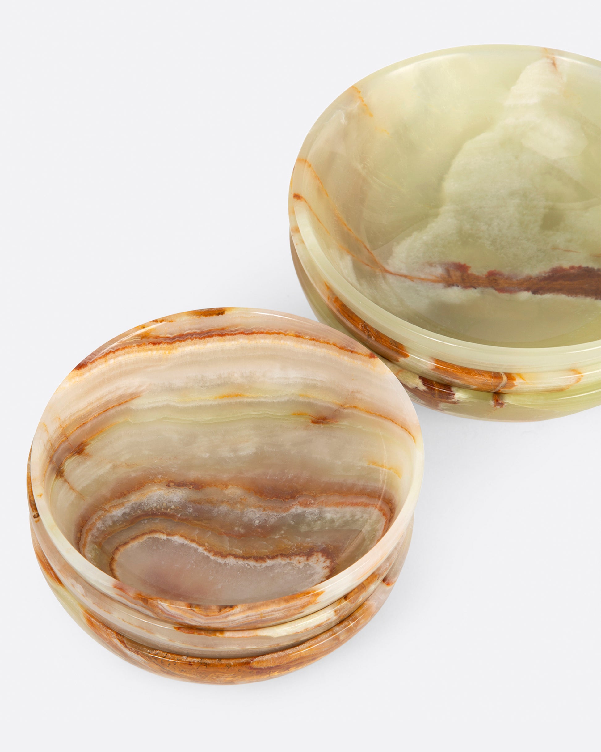 Two stacked of polished green onyx bowls, shown from above.
