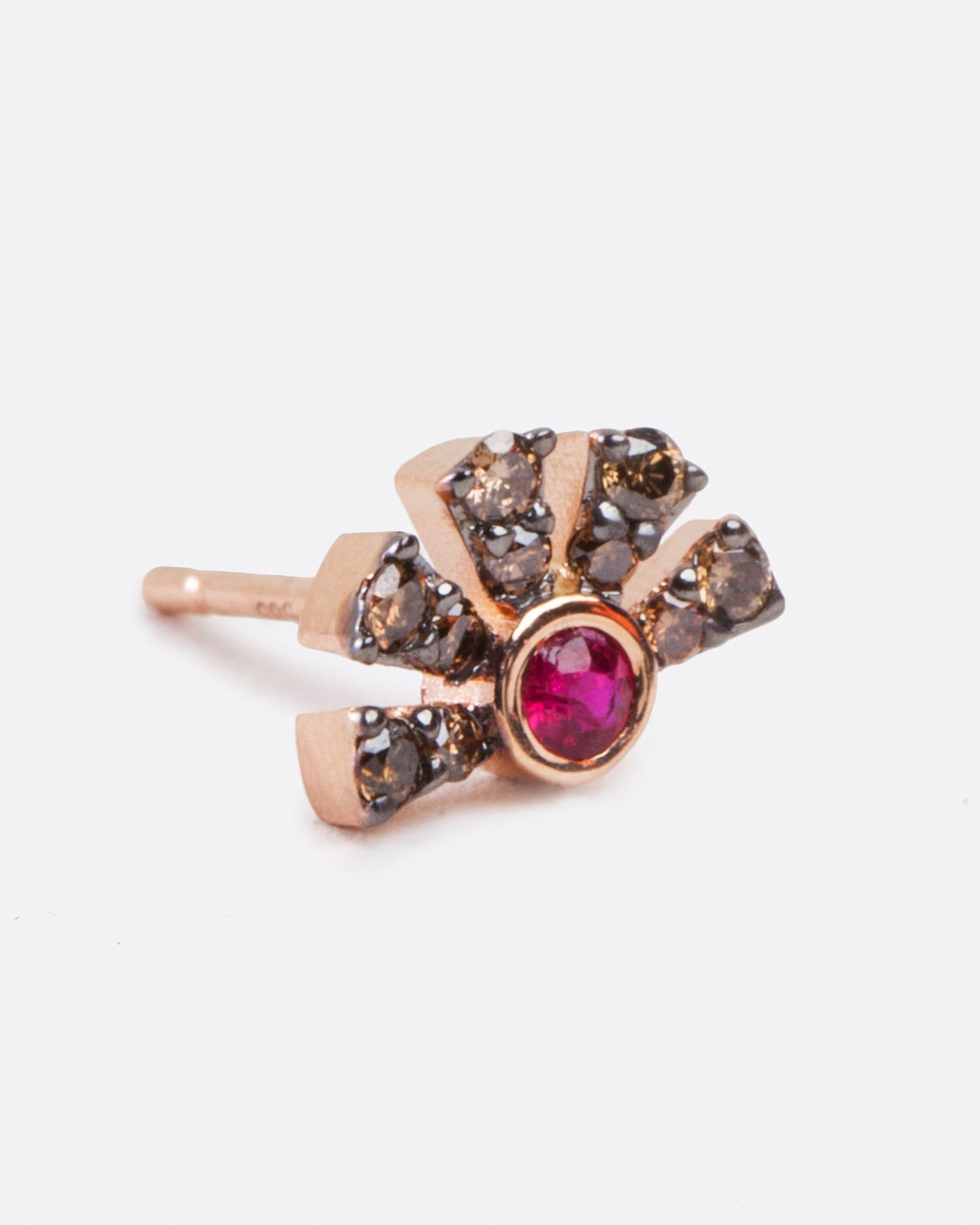 a single rose gold earring with a ruby in the middle and five black diamond pave bars extending from the ruby.