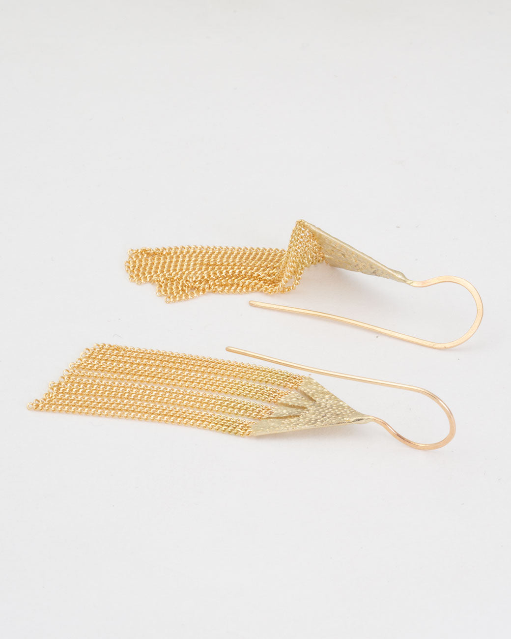 18k yellow gold icicle chain earrings by Hannah Keefe, shown laying flat.