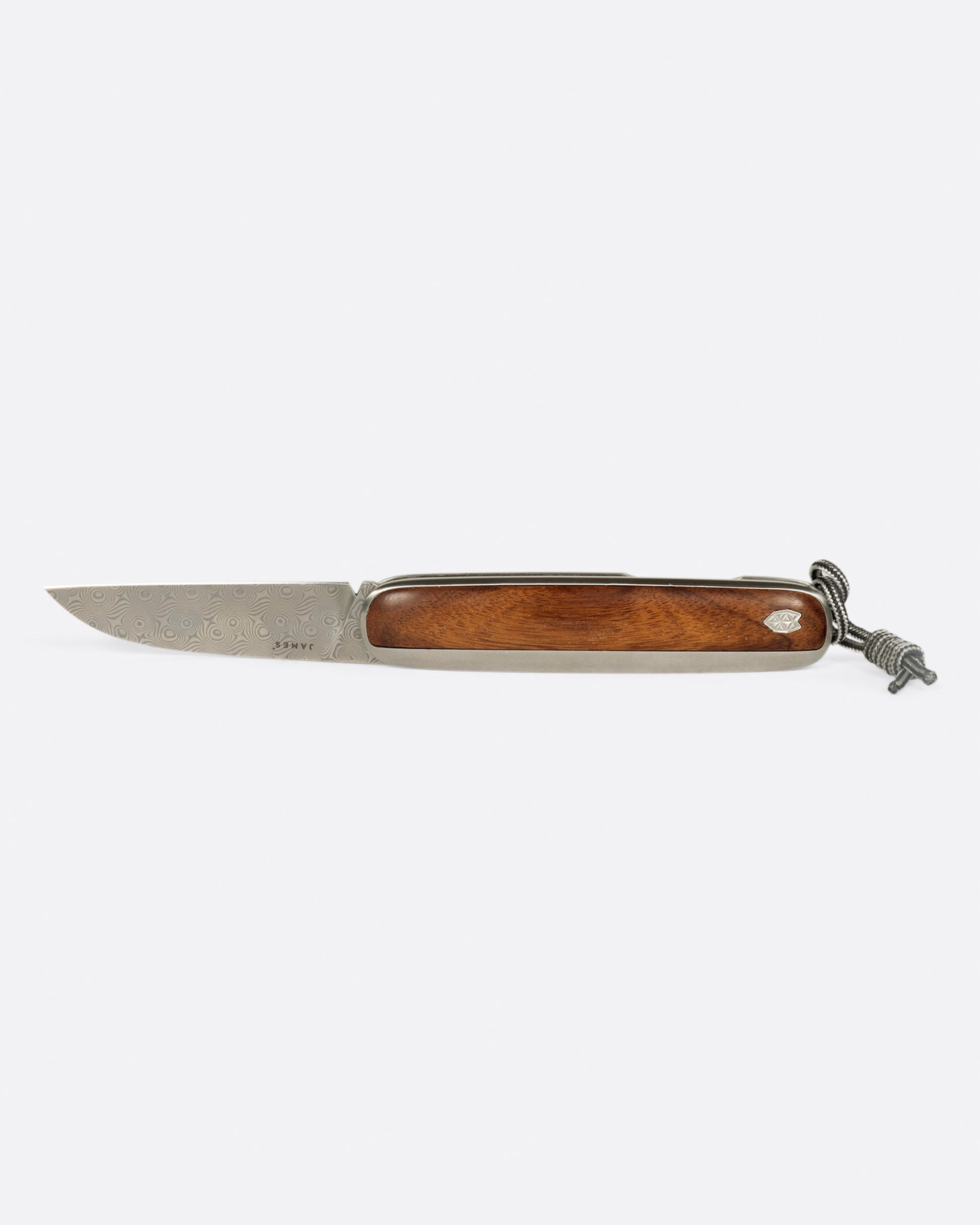 A pocket knife with a rosewood handle and damasteel blade.