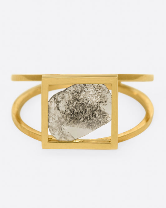 A split shank ring with a square window framing a salt and pepper diamond slice.