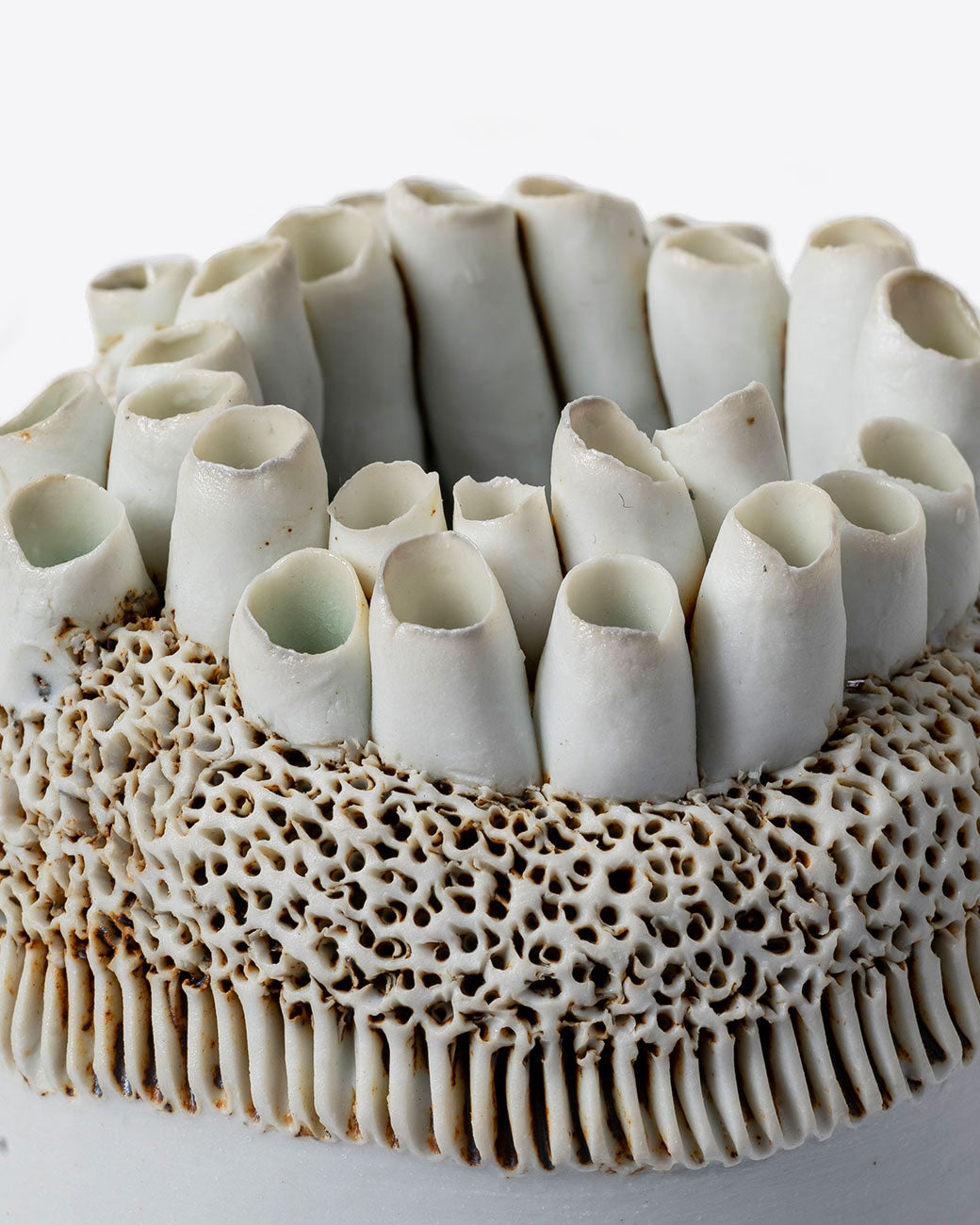 Close up of handmade porcelain barnacle motif vase by Jo Boyer.
