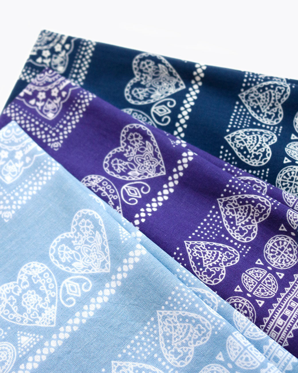 Kapital henna cube bandanas in purple, sax blue, and navy blue.