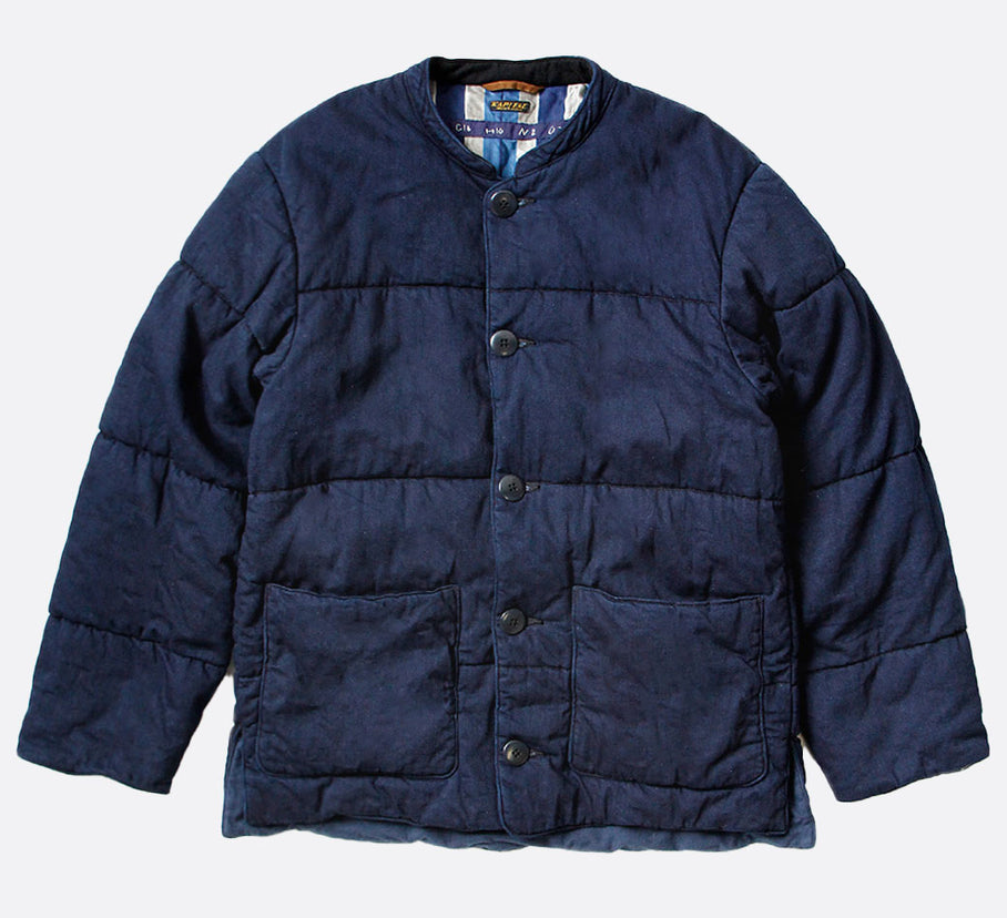 Kapital quilted denim jacket with button closure and two front pockets, shown laying flat.