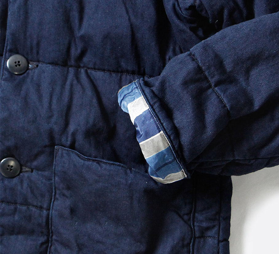 Close up of the sleeves of Kapital quilted denim jacket.