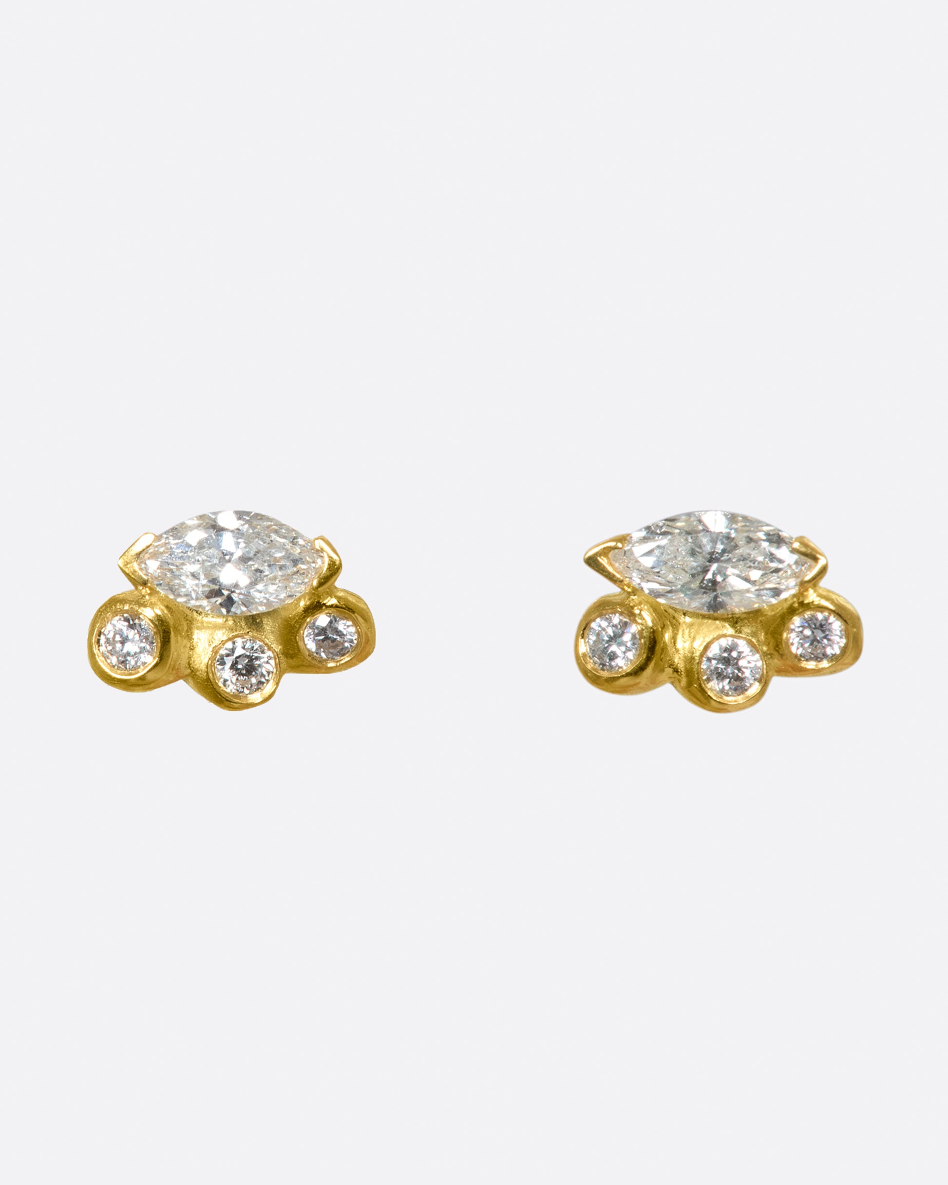 A pair of cluster studs featuring large marquise diamonds and smaller round diamonds along their edges.