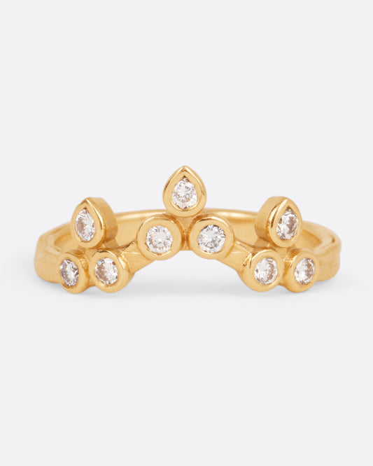 A curved yellow gold ring with a crown of round white diamonds, shown from the front.