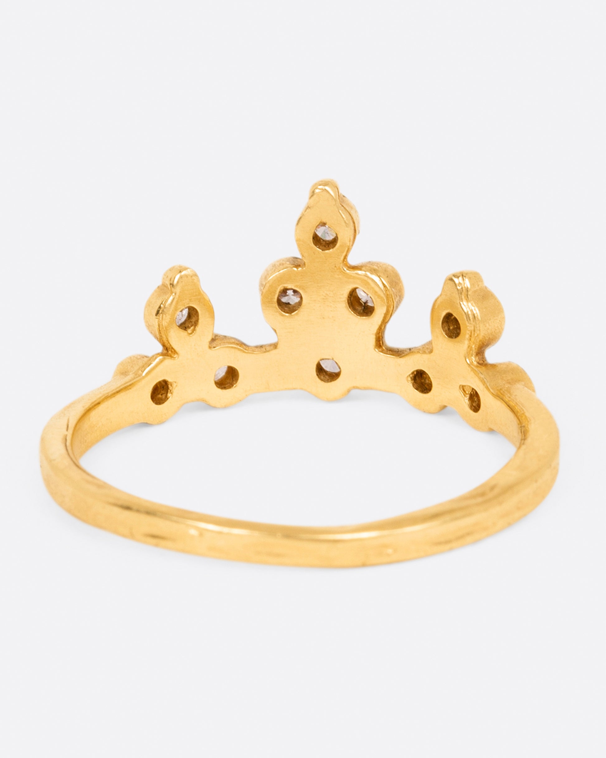A yellow gold crown ring with round white diamonds, shown from the back.