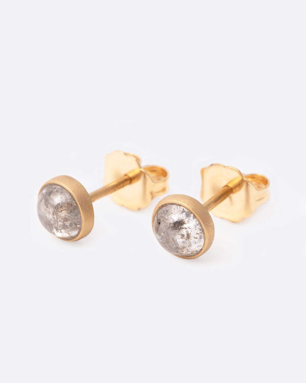 18k yellow gold stud earrings with gray diamond cabochons by Lola Brooks, shown from the side.
