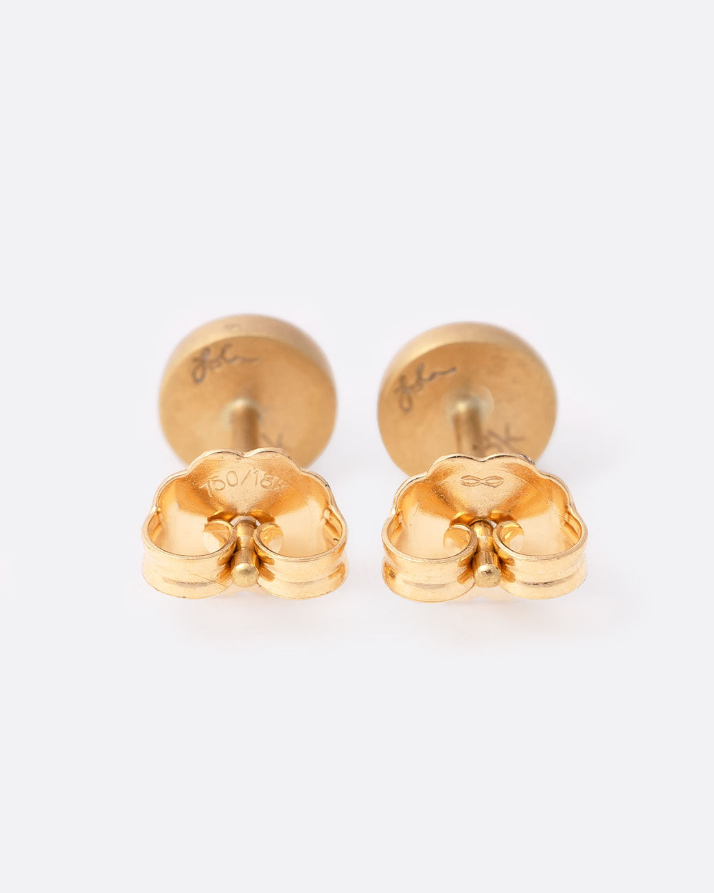 18k yellow gold stud earrings with gray diamond cabochons by Lola Brooks, shown from the back.