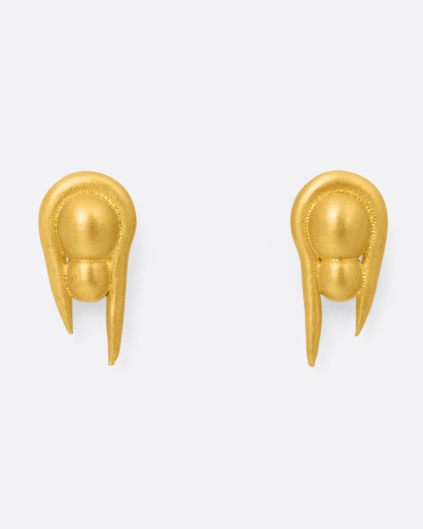 A pair of U-shaped high karat gold stud earrings with two stacked spheres at their centers, shown from the front.