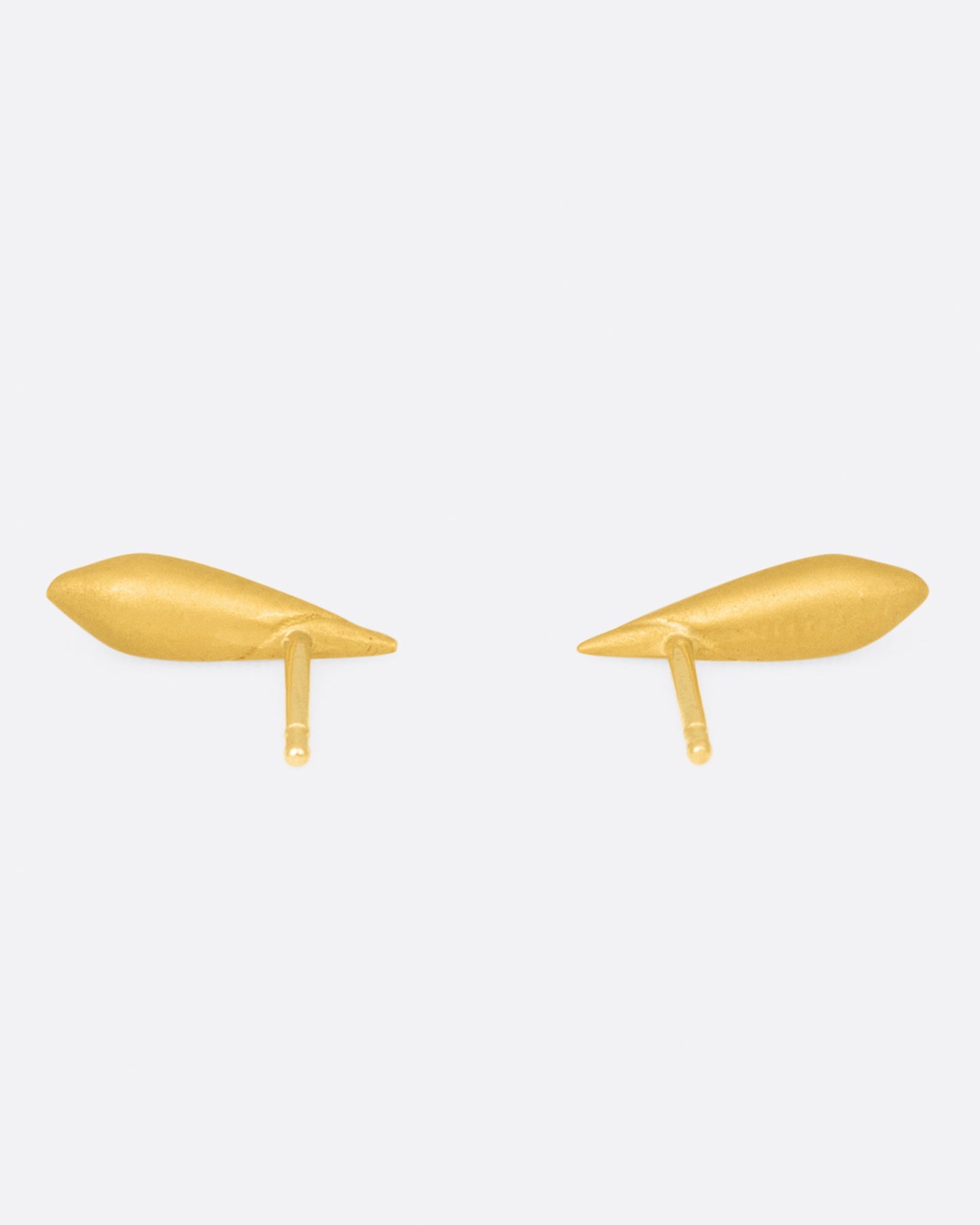 A pair cone shaped 22k yellow gold stud earring with a line following the curve of the earrings, shown from the back.