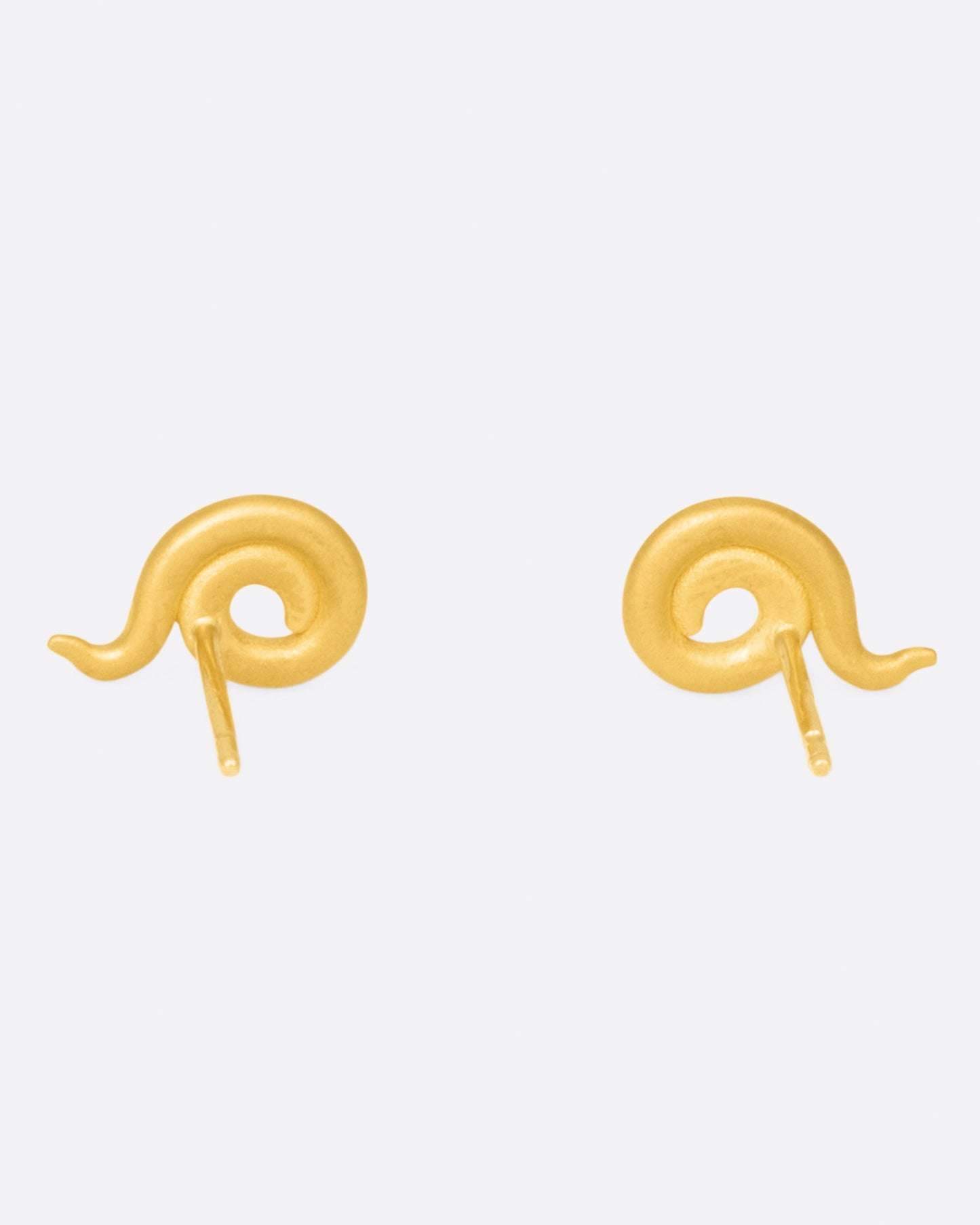 A pair of coiled 22k yellow gold stud earrings, shown from the back.