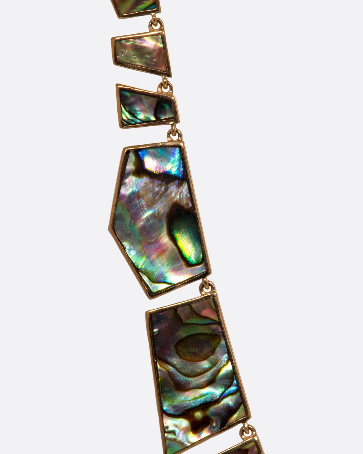 A mosaic necklace of geometric abalone shell pieces.