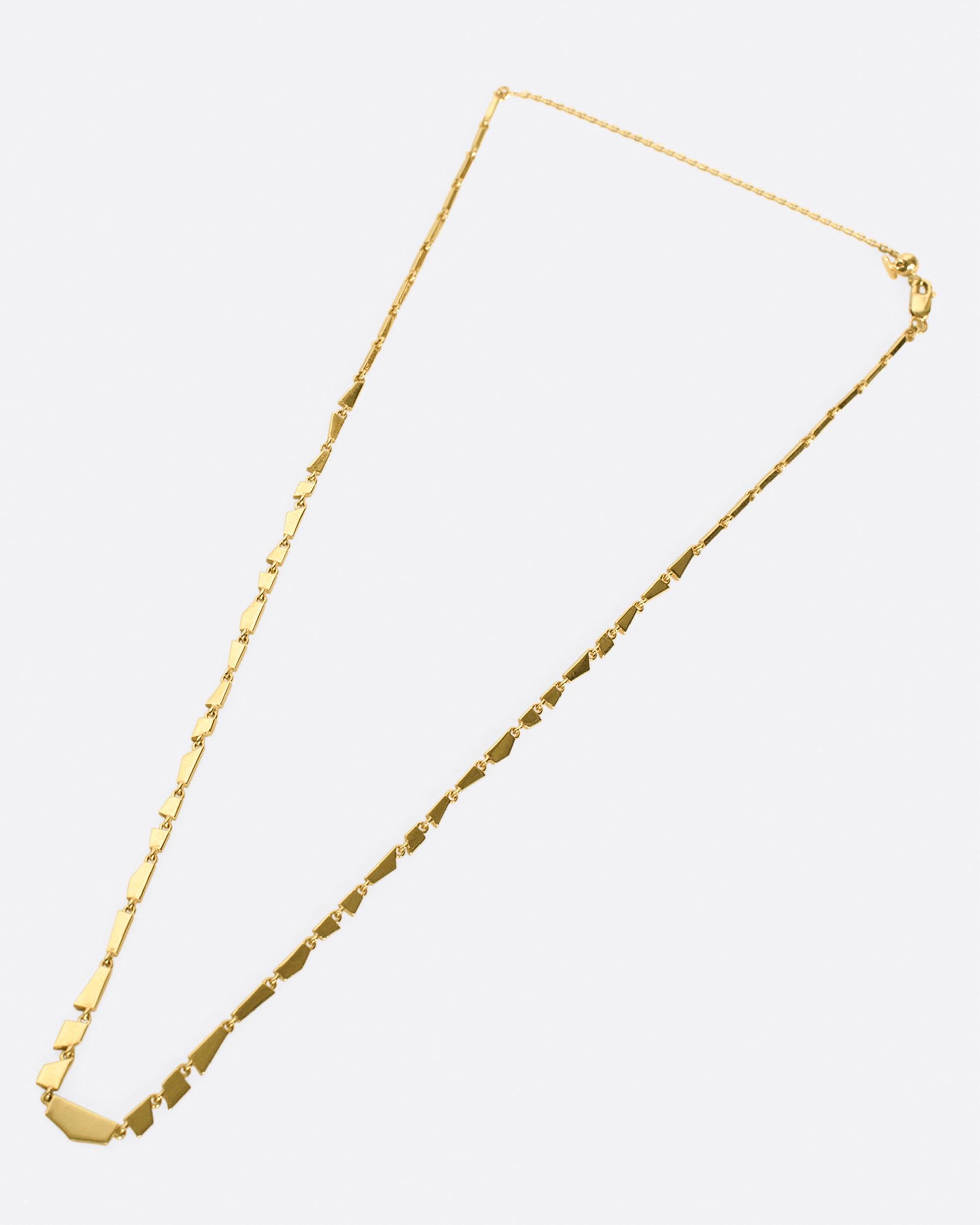 A chain necklace comprised of gold geometric segments.