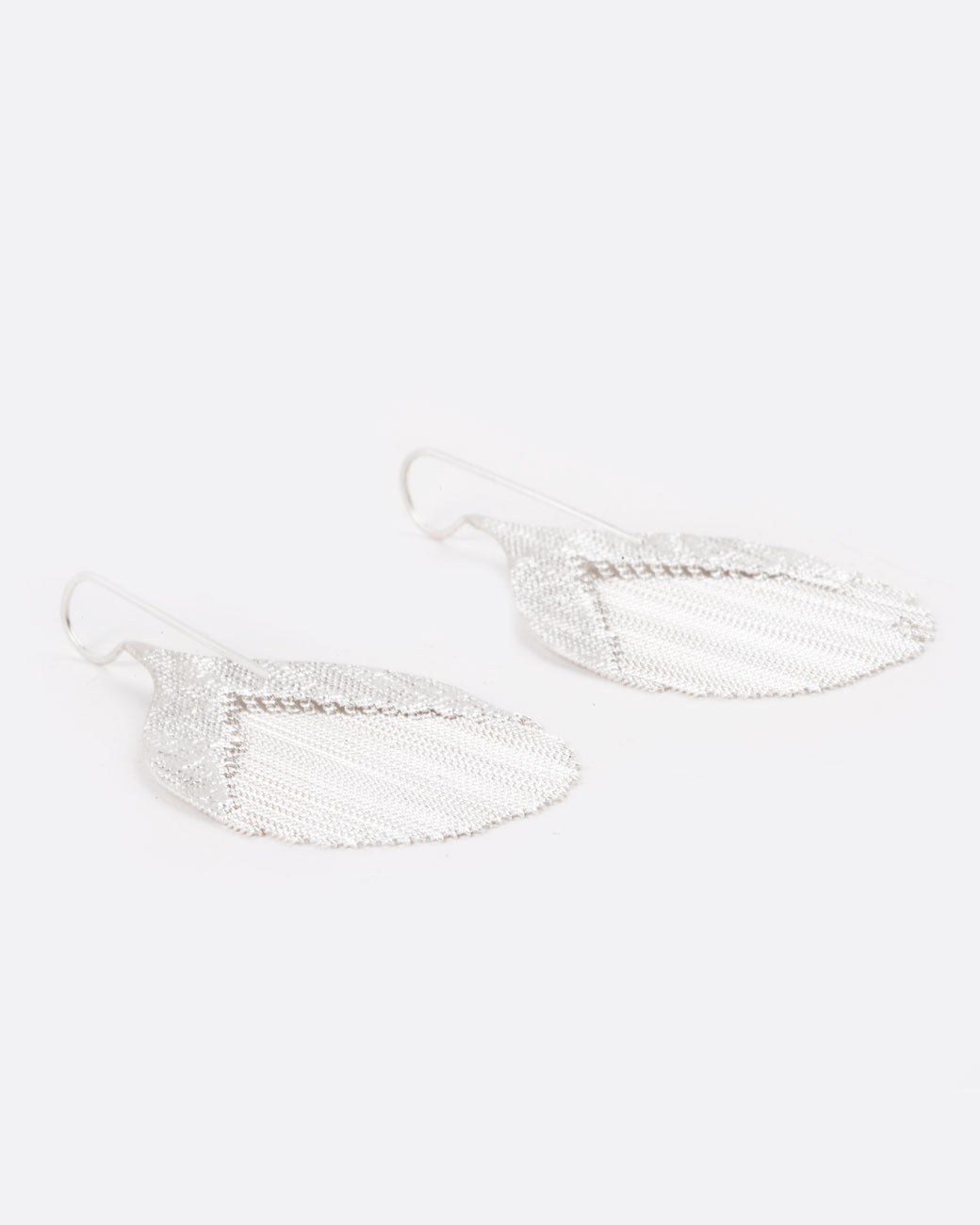 whale tail shaped earrings with a number of dangling chains in the middle
