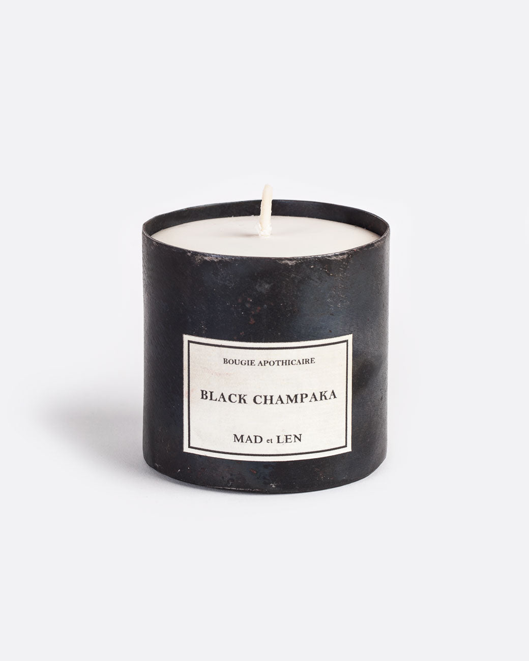 Mad et len black champaka candle measuring 3" tall and 3.25" wide. housed in a one-of-a-kind blackened iron vessel.