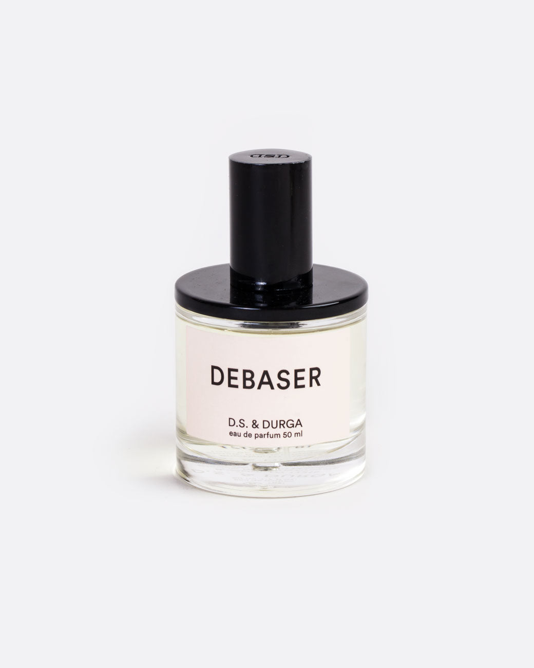 50ML bottle of D.S. & Durga Eau De Parfum: Debaser. glass bottle with black shiny top and off white label with bold san serif centered typography stating scent name