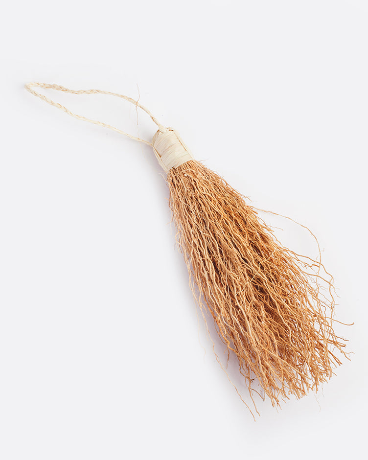 tassle of vetiver root wound tightly on one end with twine that forms a loop for hanging. vetiver is natural light honey color and twine is an off white