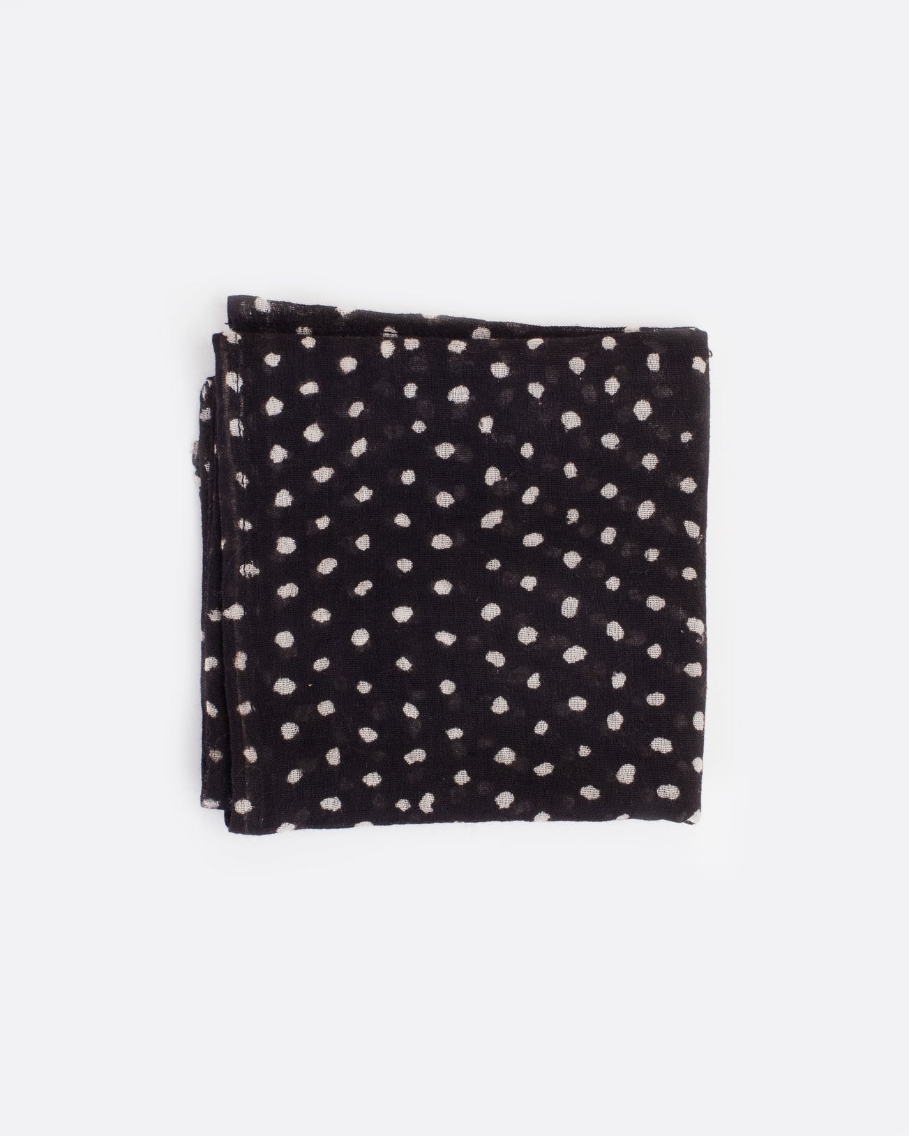 Black bandana with white polka dots, shown folded.