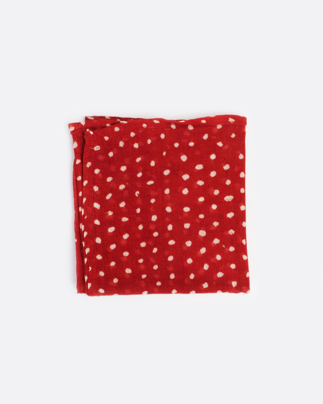 Red bandana with white polka dots, shown folded.