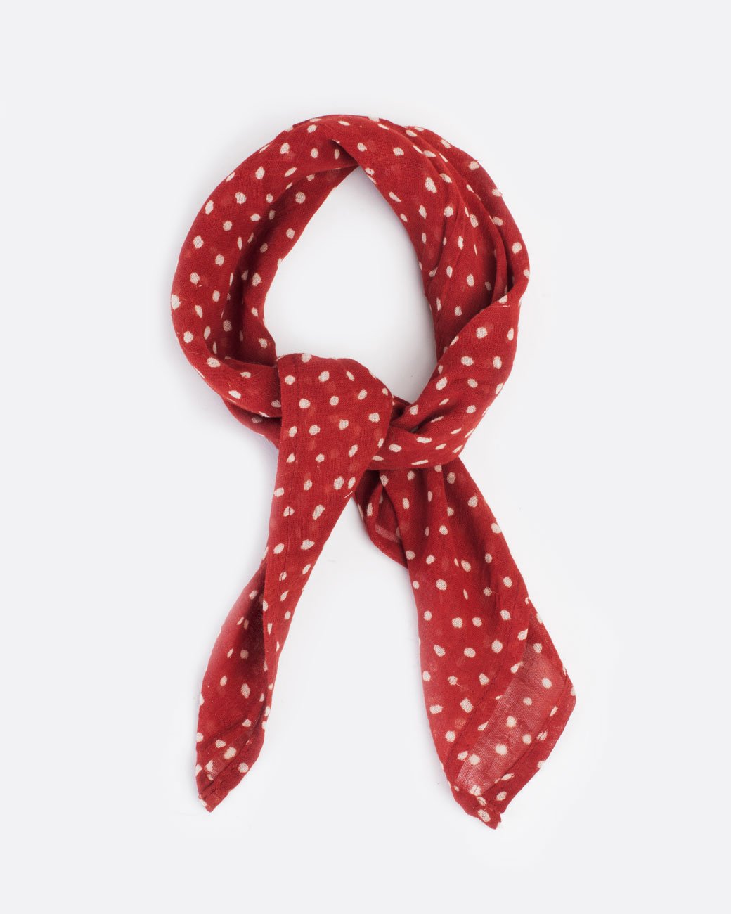 Red bandana with white polka dots, shown tied.