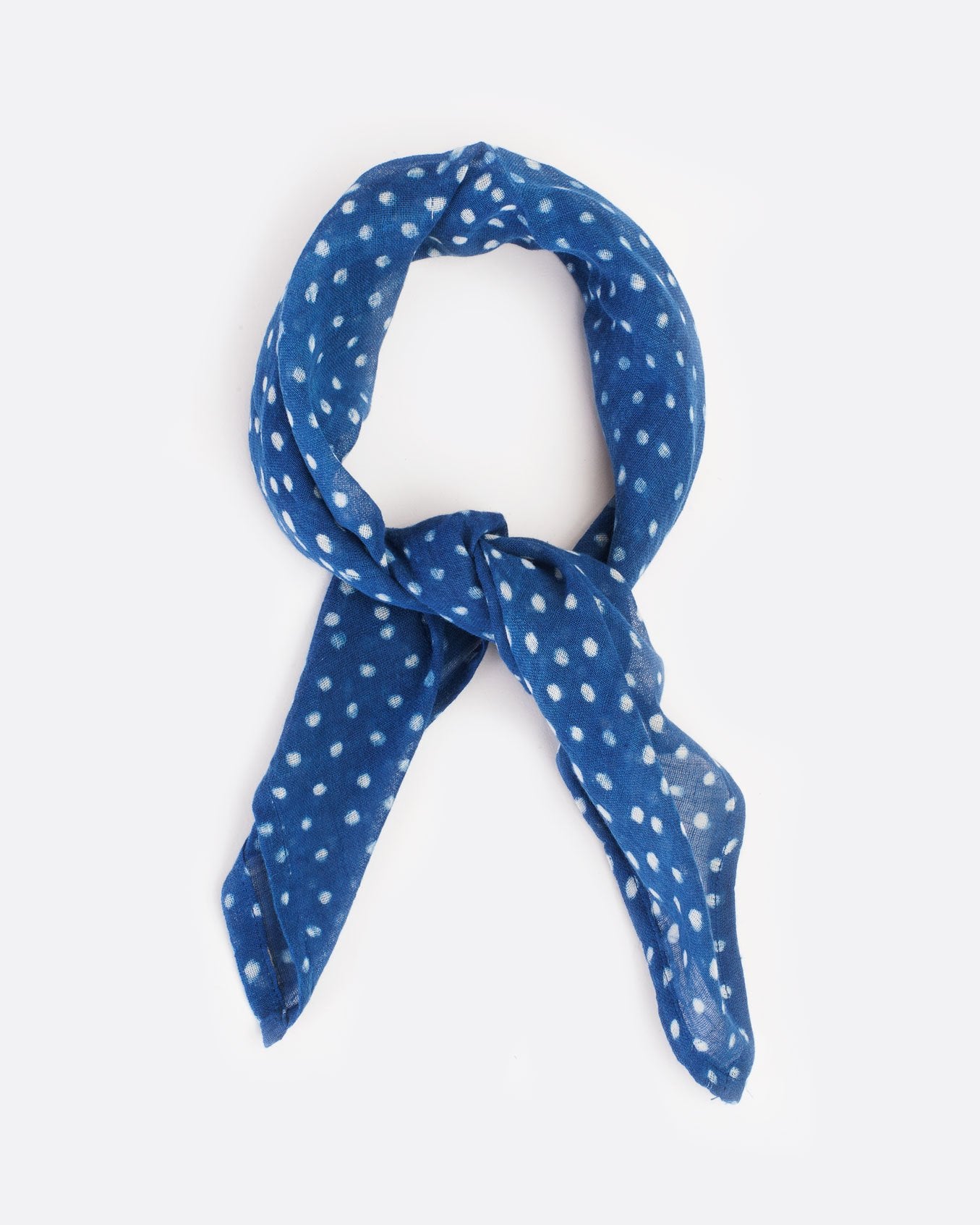 Light blue bandana with white polka dots, shown tied.