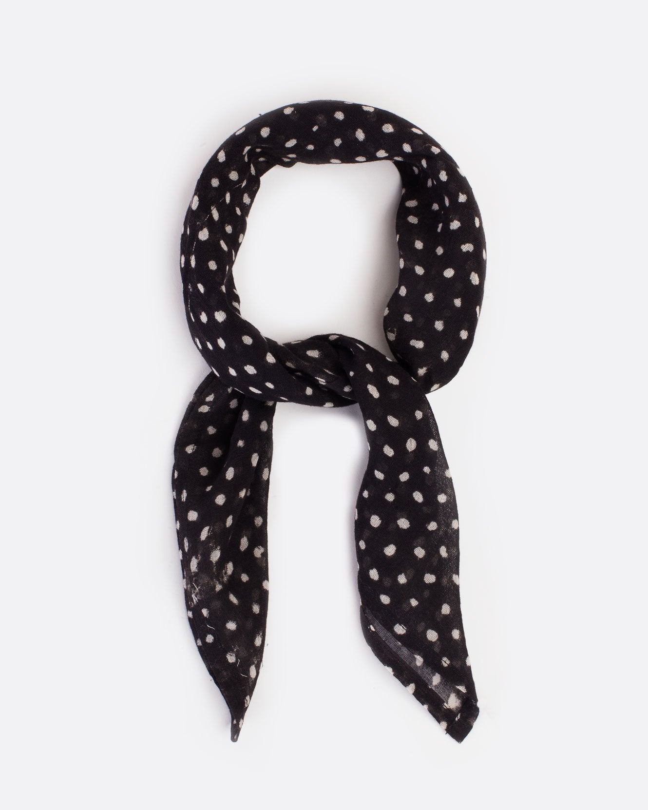 Black bandana with white polka dots, shown tied.