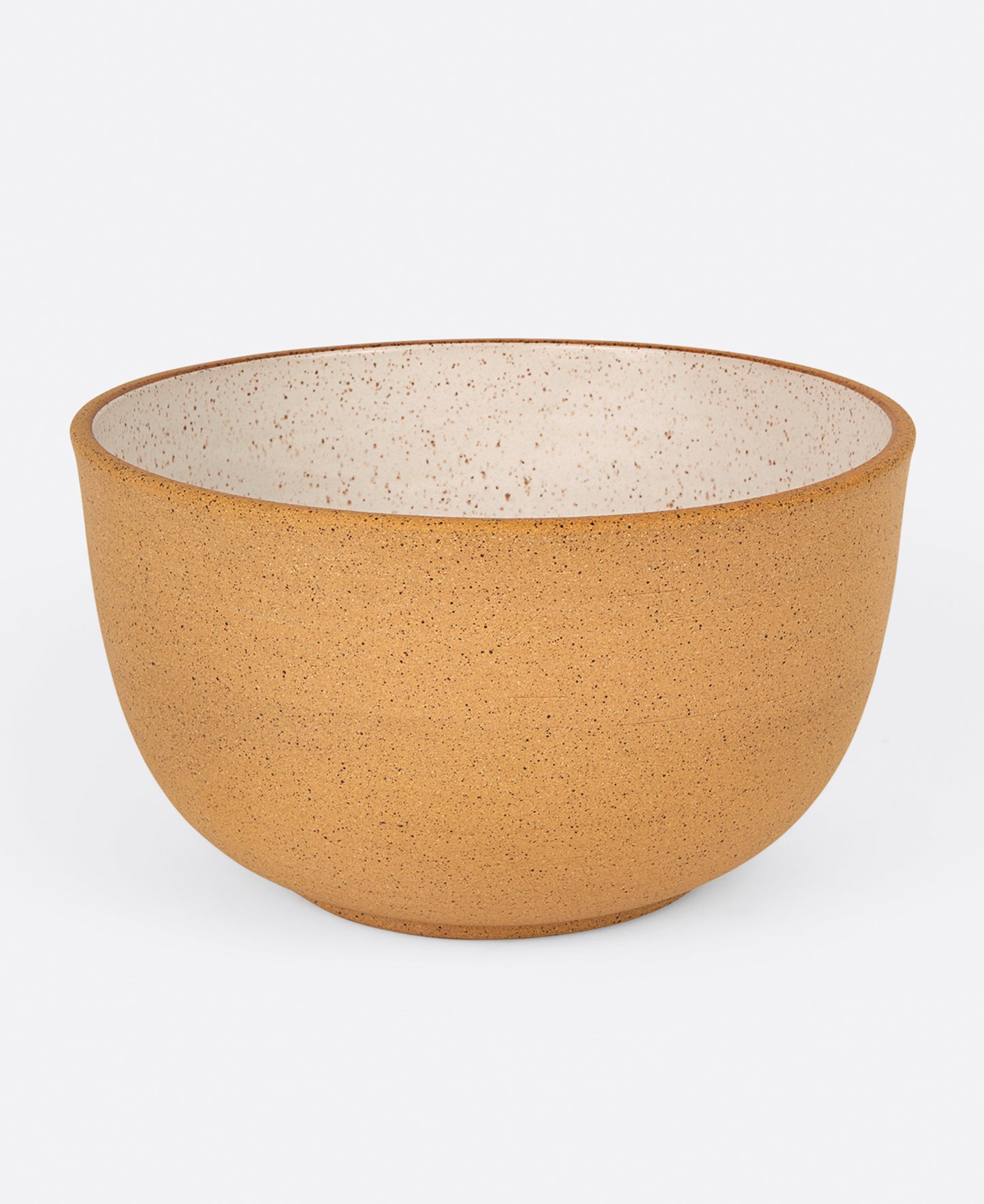 A stoneware salad bowl with a raw exterior and white glazed interior, shown from the side.