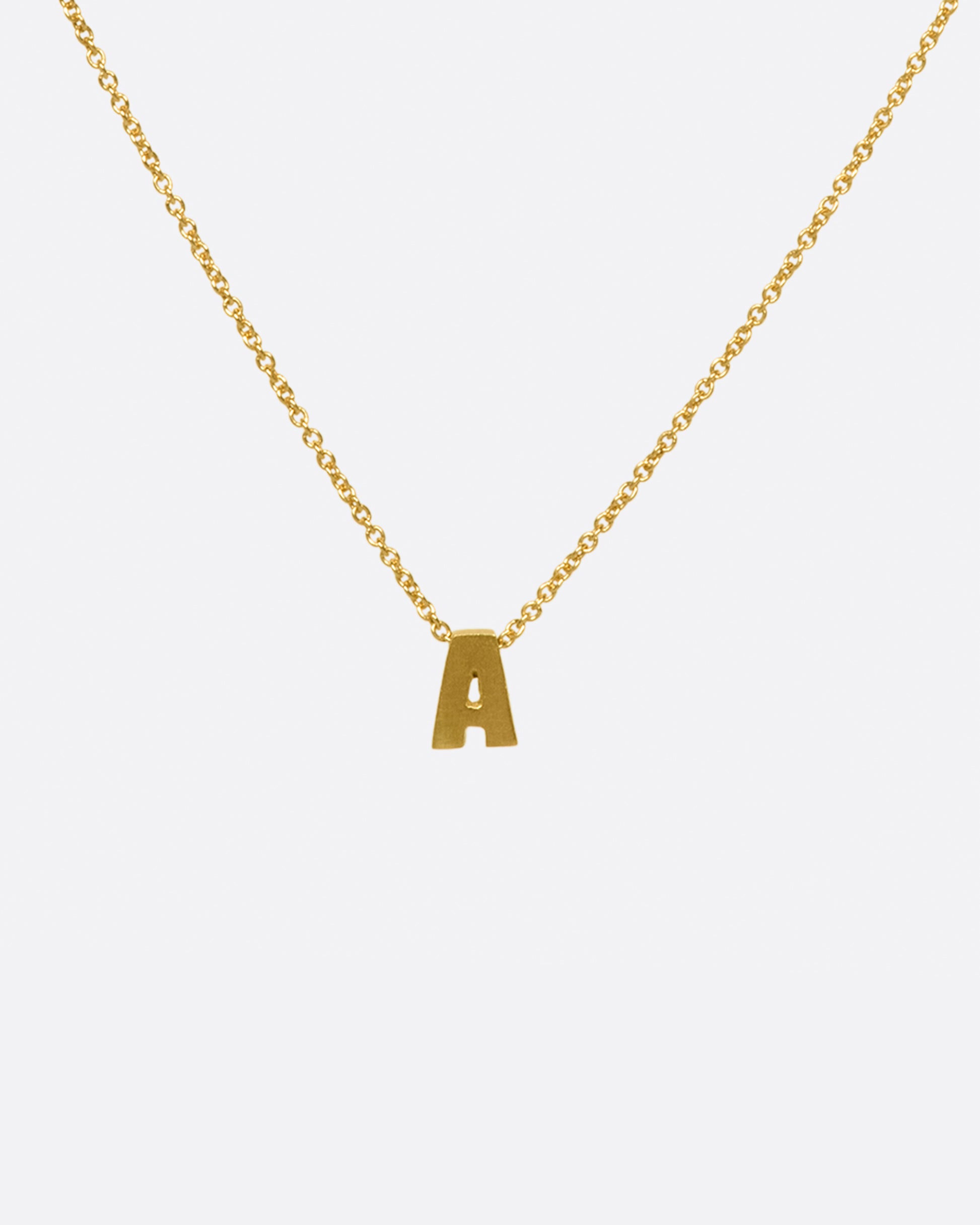 This micro initial necklace features a block letter of your choice hanging from a cable chain with an optional separate bezel set diamond tag.