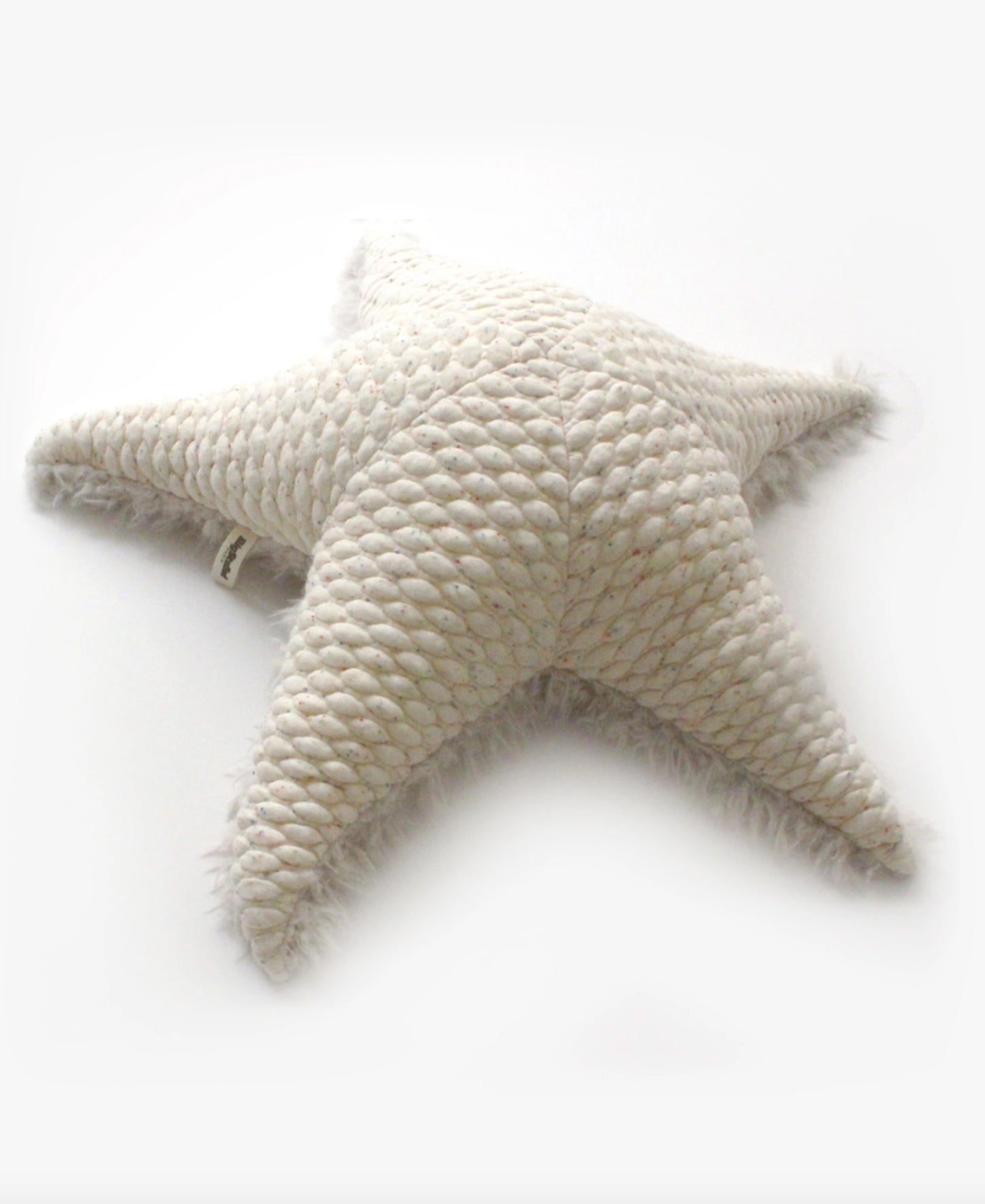 An off-white starfish stuffed animal, shown from above.
