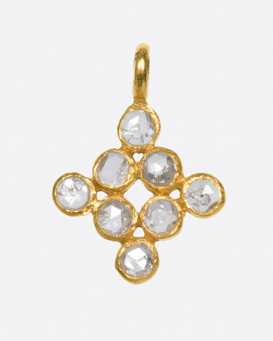 A yellow gold charm with eight rose cut diamonds set in a diamond shape. Shown from the front.