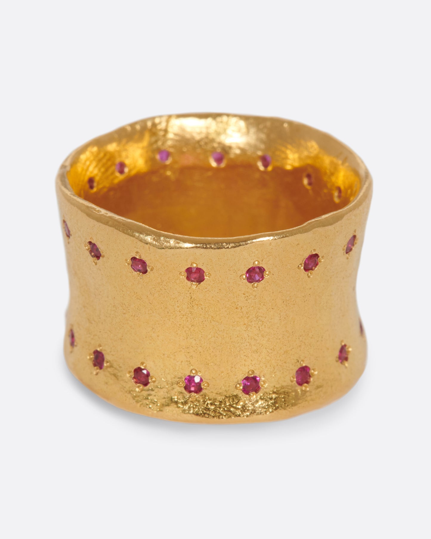 A slightly concave 22k gold band lined with thirty two rubies.