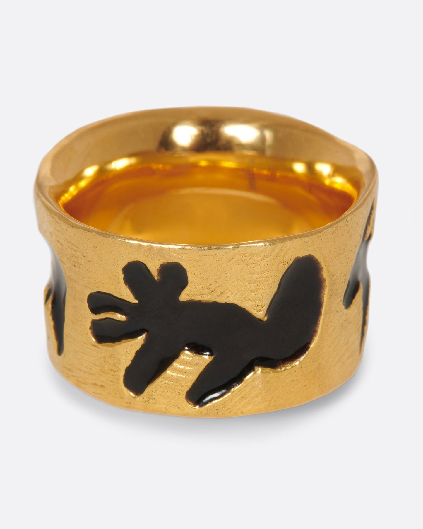 A high karat gold band with a range of different black enamel animal silhouettes.