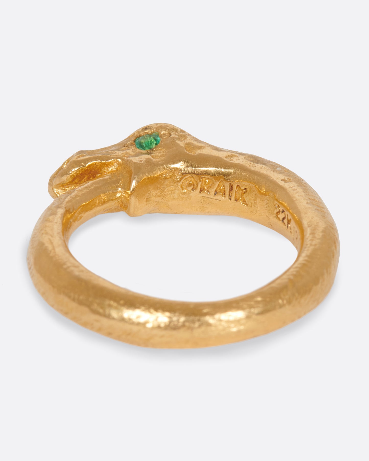 A high karat gold ouroboros ring showing a serpent catching its own tail.