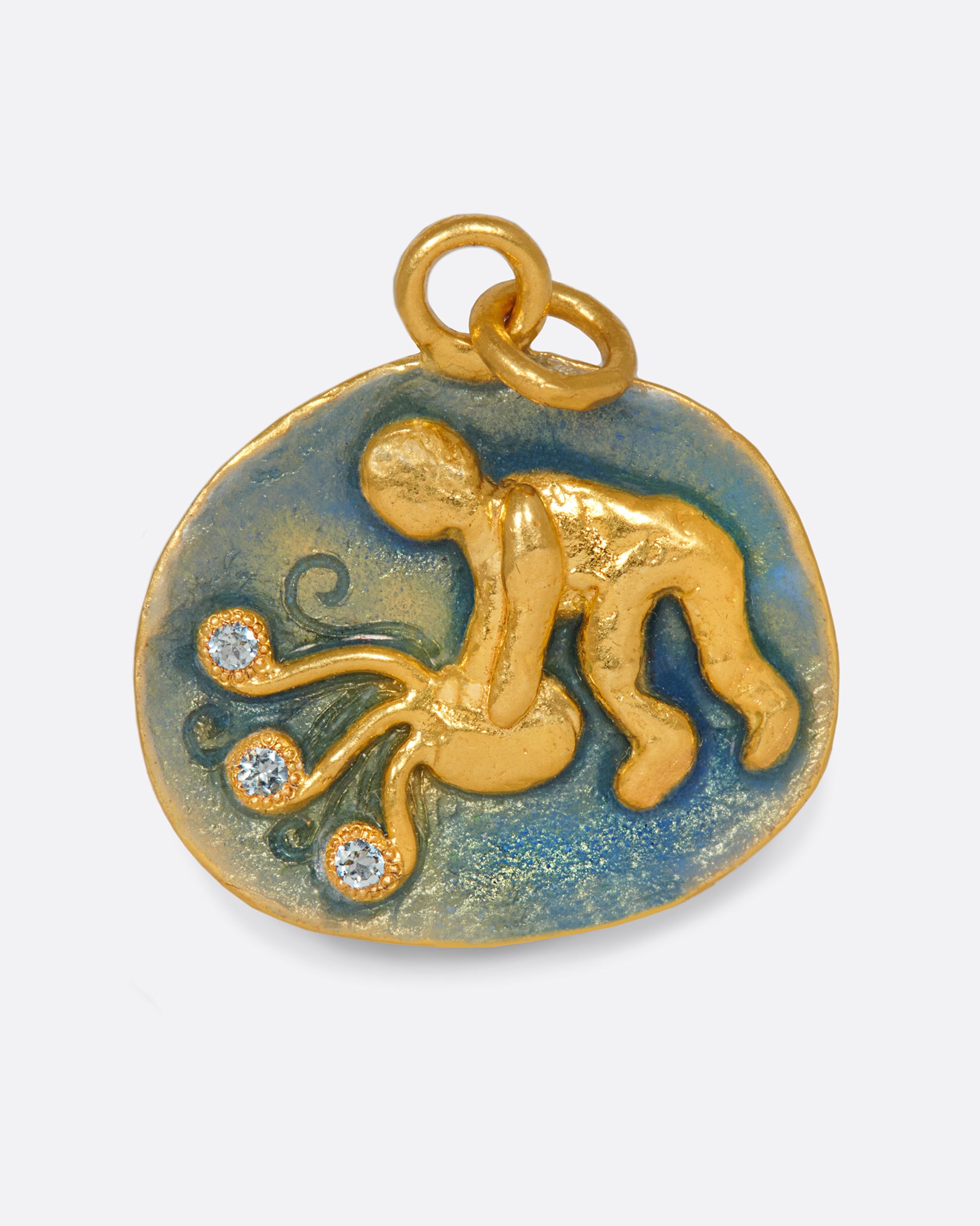 A hand formed medallion pendant with an Aquarius icon, pouring water dotted with aquamarines.