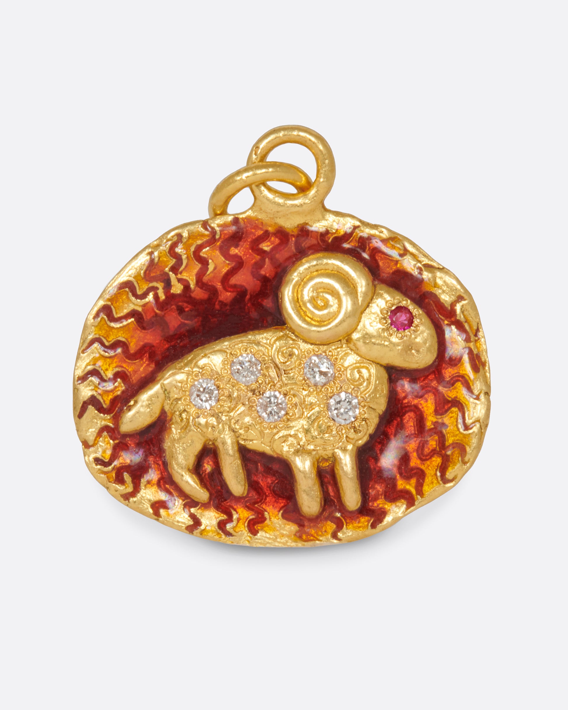 An oval pendant with an Aries symbol accented by squiggly etchings, diamonds and a ruby.