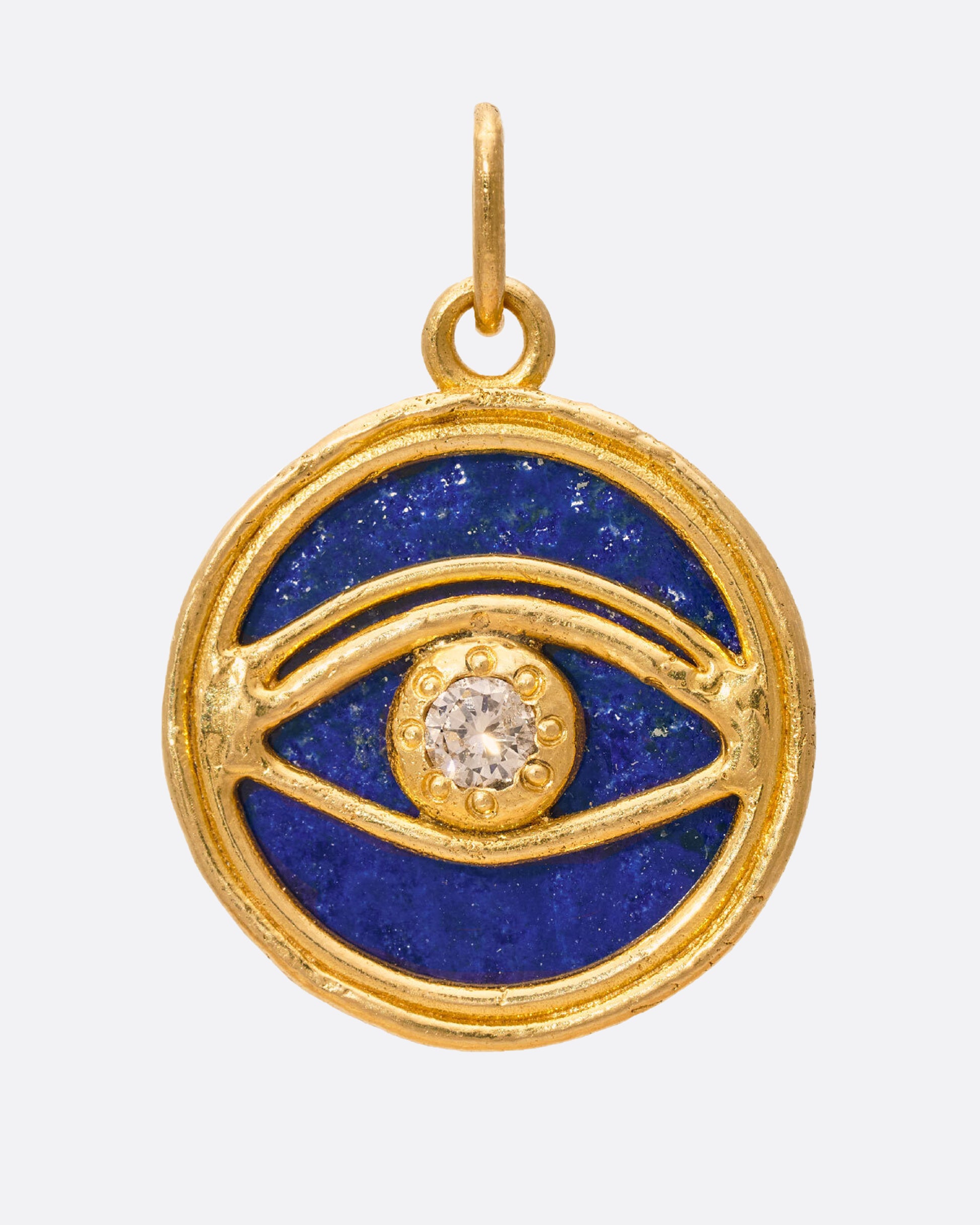 A round lapis Inner Eye pendant decorated with 22k gold and diamond details.