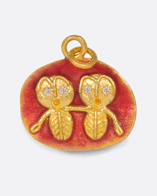 A high karat gold medallion pendant with a pair of hand-sculpted Gemini twins.