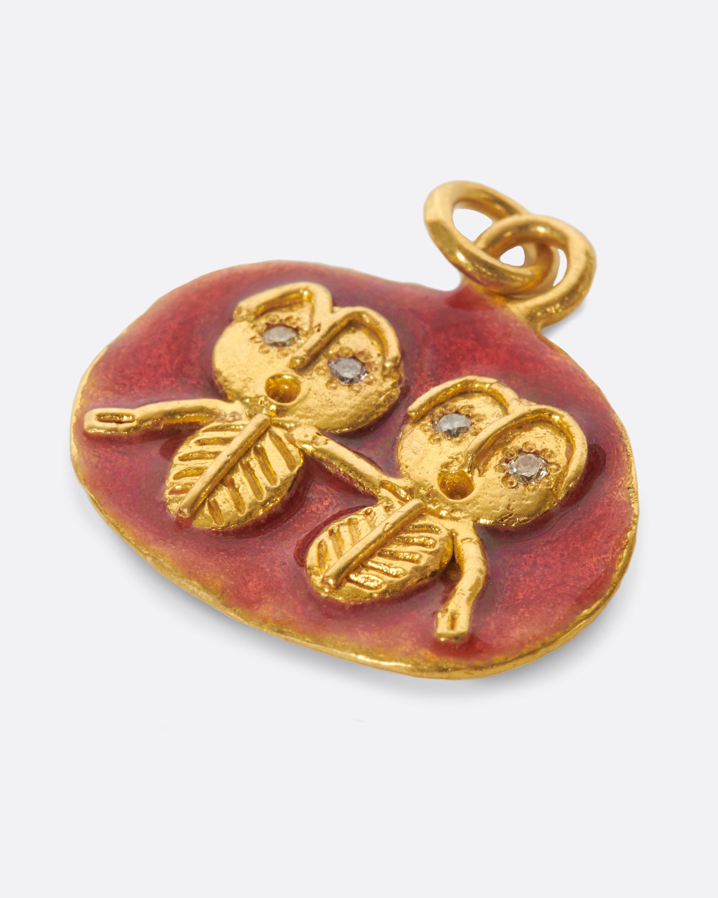 A high karat gold medallion pendant with a pair of hand-sculpted Gemini twins.