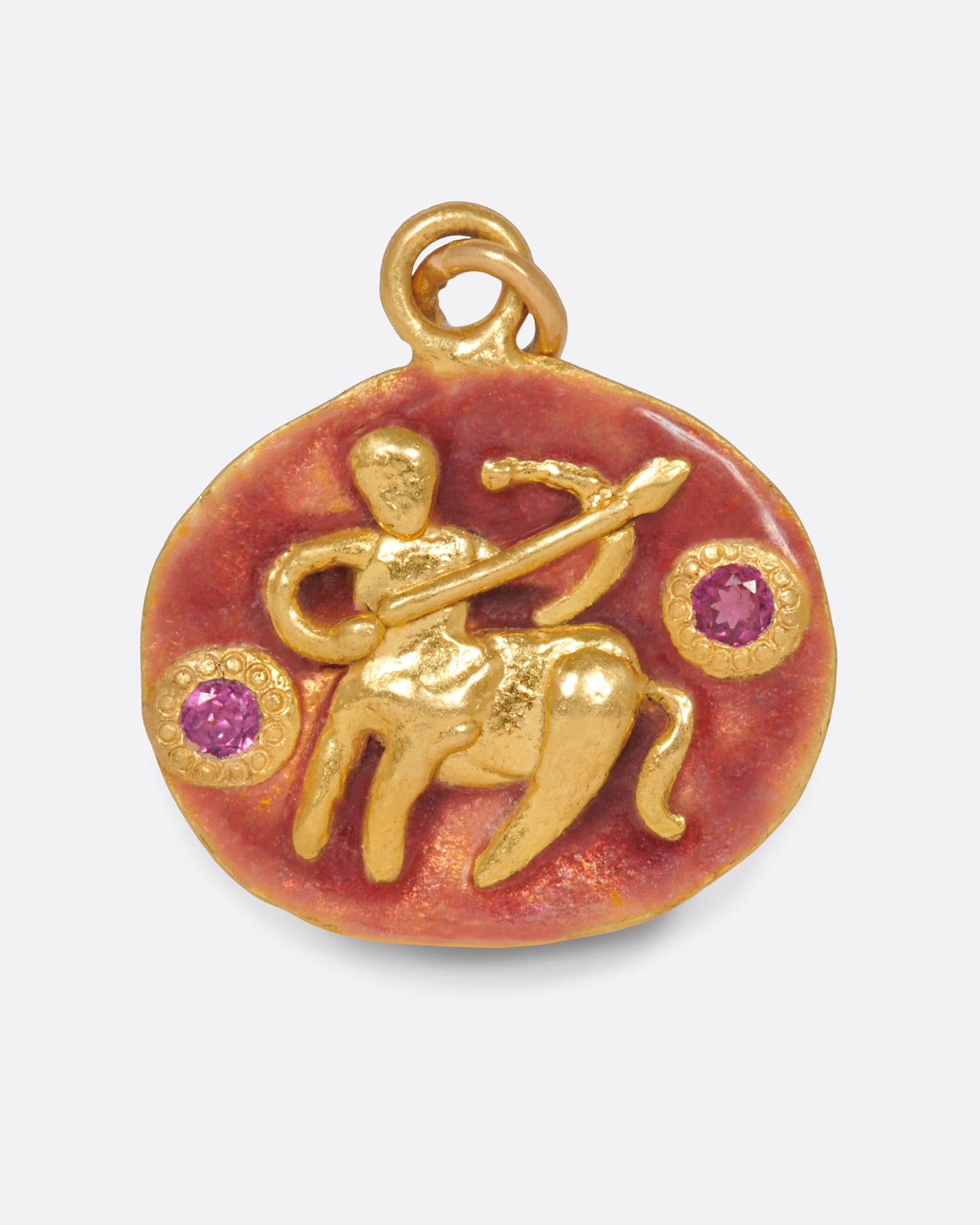 An oval gold pendant with rosy pink enamel and a hand-sculpted Sagittarius icon.