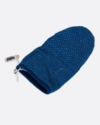 A blue hand stitched oven mitt. Shown lying flat.