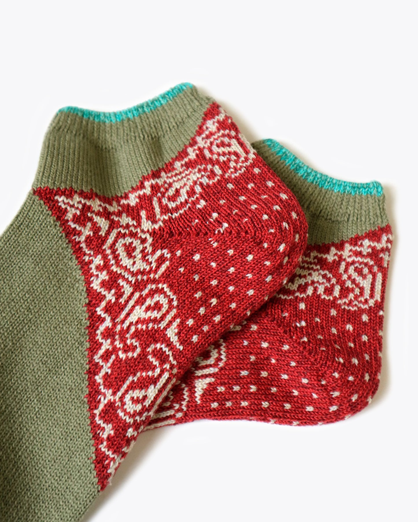 A pair of moderately thick ankle socks with a paisley bandana heel.