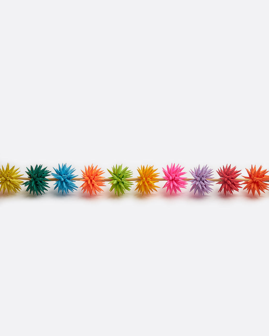 A multicolor paper starburst garland, shown from the side.