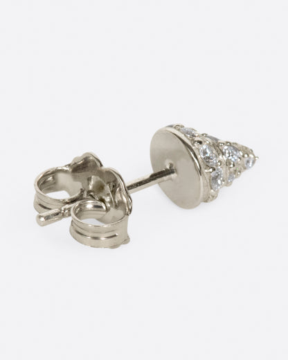 A white gold conical stud earring, with diamond accents, shown from the back.