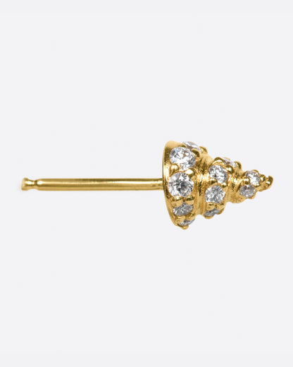 A yellow gold conical stud earring, with diamond accents, shown from the side.